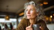 © Johannes - thoughtful mature woman sitting in cafeteria holding coffee mug while looking away middle aged woman drinking tea while thinking relaxing and thinking while drinking coffee no logos no brands ar 169