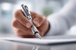 © whitestorm - Close-up of a hand writing with a classic fountain pen on a document.