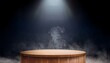 © Juana - the empty wooden cylinder shape of product display podium stand for showing or design blank backdrop dark abstract wall with smoke float up platform illuminated by spotlights
