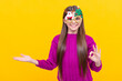 © Olena - happy kid in party glasses presenting product on yellow background, new year
