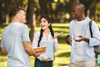 © Prostock-studio - Happy internatial students friends talking during break, walking in university campus, holding books and laughing, free space. College life