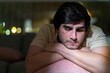 © Guillermo Spelucin - Young man struggling with depression and sadness at home