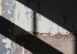 © anggit - Abstract Wall Texture with Peeling Paint and Diagonal Shadows, Depicting and Gritty Surfaces