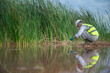 © akarapon - An environmental expert is collecting water samples to check the abundance of natural water sources.
