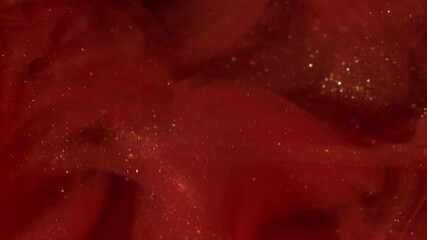 Wall Mural - Spreading glitter. Paint swirl. Art sparkling particles water flow. Vibrant color emulsion explosion red orange abstract background.