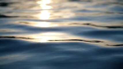 Wall Mural - A close-up, shallow depth of field shot focuses on the abstract patterns of sunlight dancing on the gently rippling lake surface abstract patterns, water surface, bright