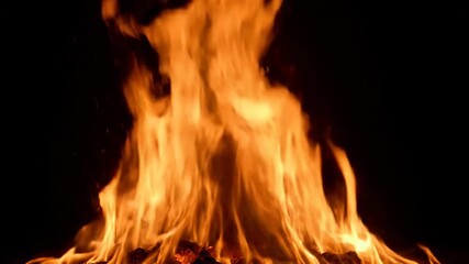 Wall Mural - dynamic slow motion shot of a powerful, large orange flame erupting and spreading aggressively in da