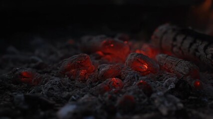 Wall Mural - Glowing embers of a dying fire slowly fading to cold ash as the last heat dissipates in the darkness embers, grey, texture