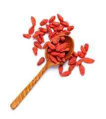 Wall Mural - Wooden spoon with red dried goji berries on white background