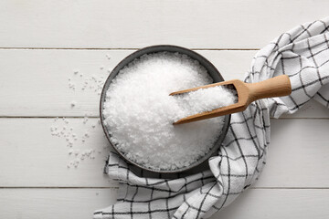 Wall Mural - Bowl with sea salt and napkin on light wooden background