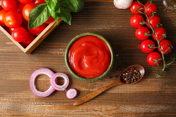 Wall Mural - Bowl of tasty tomato sauce and different ingredients on wooden background