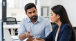 © zabhie - Indian Mentor Teaching Female Intern in Modern Office Setting
