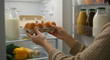 © Alina - Asian woman placing eggs in refrigerator shelf with groceries, fresh food and nutrition concept