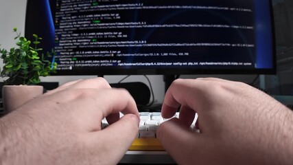 Programmer's hands typing code on a modern mechanical keyboard, with programming script visible on a dark monitor, illustrating software development