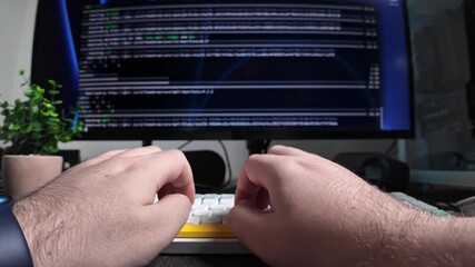 Person typing on a modern white keyboard with yellow keys, showing programming code on a screen, representing software development and digital work. Zoom
