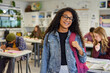 © Rido - Multiethnic girl student standing in classroom with a big smile