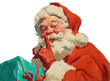 © samotan - Vintage santa claus holding a gift and gesturing for silence, isolated on transparent background