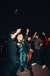 © Jacob Lund - Friends celebrating outdoors during a festive nighttime gathering