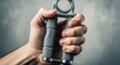 © mlangsen - Hand grips a gray and silver spring-loaded hand exerciser for strength training
