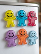 © SashaMagic - Colorful smiley face magnets on a fridge.