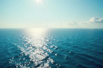 Wall Mural - vast, tranquil ocean stretching to the hazy horizon, sunlight shimmering on the water perfect for tr