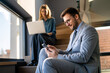 © NDABCREATIVITY - A confident business man leads her busy office life, multitasking with smartphone communication