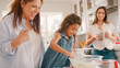 © Monkey Business - Three Generation Female Family In Kitchen At Home Having Fun Baking Together