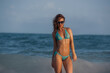 © aleonovs - Confident Redhead in Turquoise Bikini Standing in Ocean Wave