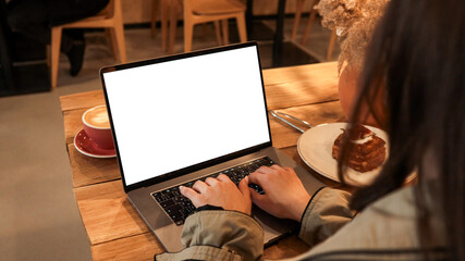 Girl using laptop in a cafe
