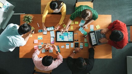 Top view of software developer writing idea about Ux ui design for mobile phone interface. Programmer brainstorm and planning wireframe prototype by looking tablet display smart software. Convocation.