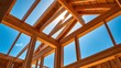 © Lynniee - House construction framing with wooden structure against blue sky.