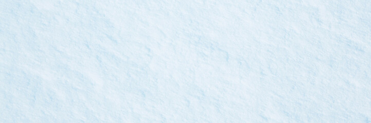 Wall Mural - Natural snow texture. Smooth surface of clean fresh snow. Snowy ground. Wide panoramic winter background with snow patterns. Perfect for Christmas and New Year design. Closeup top view.
