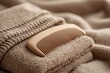 © Asiah - Wooden Comb Resting on Folded Towel in Soft Texture