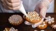 © Enigma - Hands in gloves decorating a festive gingerbread cookie with white icing, creating holiday patterns and capturing the spirit of christmas baking and homemade treats