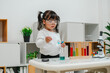 © geargodz - toddler girl scientist study using pipette dropping liquid with test tube and beaker. learning science