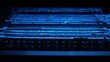 © Anda - rack. Close-up of glowing blue server rack lights creating an abstract technological pattern on a dark background. product launch decks.