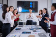 © Wasana - Business team clapping in meeting room celebrating successful presentation
