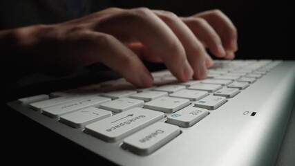 Close-up man typing on computer keyboard with hands and fingers. Macro soft focus dolly shot. Computer programming, text chat online messaging and online marketing business concept. Glean