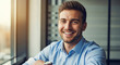 © Morooccan - Smiling man in office with sunlight.
