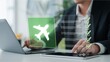 © Graphics_Bazaar - Businessman using a digital tablet and laptop to manage his travel plans, interacting with a virtual flight checklist for online booking and insurance