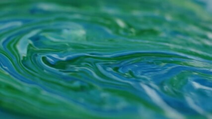 Poster - Serpentine patterns of flowing liquid in natural greens and blues, forming a mesmerizing, seamlessly looping video liquid, patterns, organic