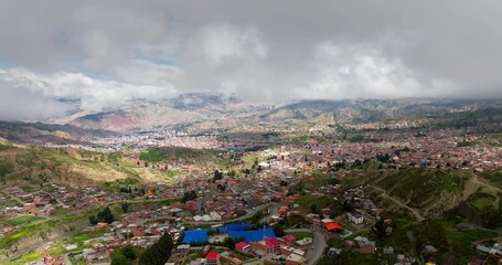 Wall Mural - Los Rosales neighborhood in La Paz, dense cityscape built into mountain valley in Bolivian Andes, Bolivia. Aerial forward