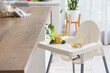 © Pixel-Shot - Baby highchair with puree, broccoli and toy in kitchen