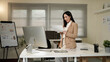 © Stella 16 - Business asian woman reading document paper on working table at office