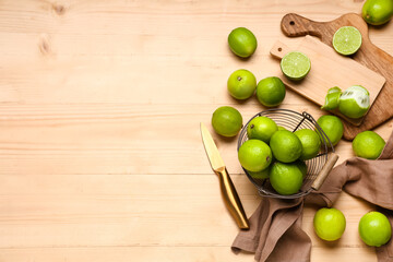 Wall Mural - Basket and cutting board with fresh ripe limes on wooden background