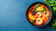 © Chineewan Somsap - Vibrant bowl of seafood soup featuring shrimp, mussels, and fresh vegetables, garnished with herbs and citrus slices, evokes sense of warmth