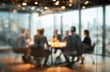 © Andy - Blurred image of a diverse group of professionals having a meeting around a conference table