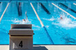 © pavel1964 - Detail of the start block with the number 4. In the background swimmers are swimming the backstroke