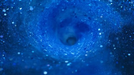 Wall Mural - Hypnotic blue glitter particles swirl and dance in a captivating liquid vortex in a timelapse dark, deep, energy
