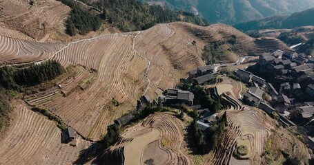 Wall Mural - Drone flight over patterned Longsheng rice terraces and rural hillside homes near Guilin, China